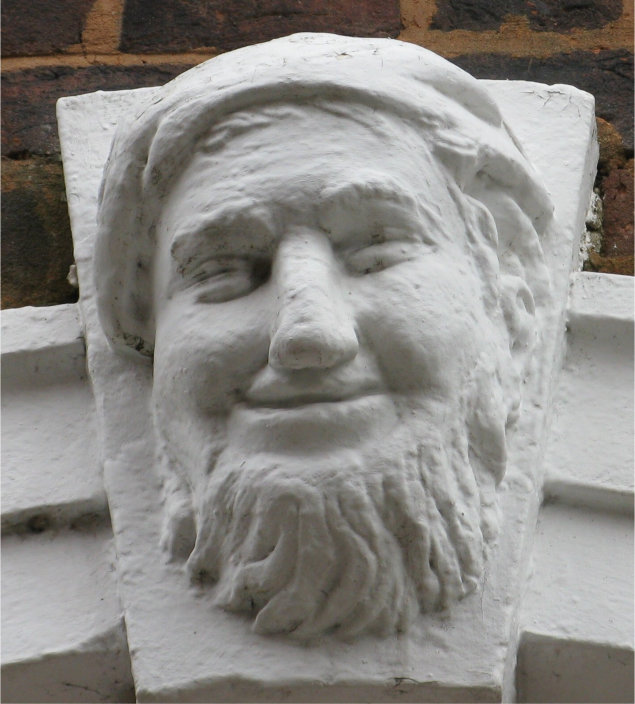 Coade stone head Exeter. Photo (c) J. G. Betts Coade stone face over doorway.