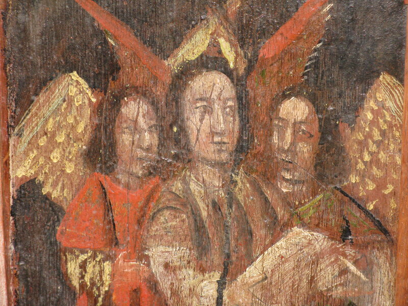 3 angels singing  on chancel door of St Winwaloe's church Devon